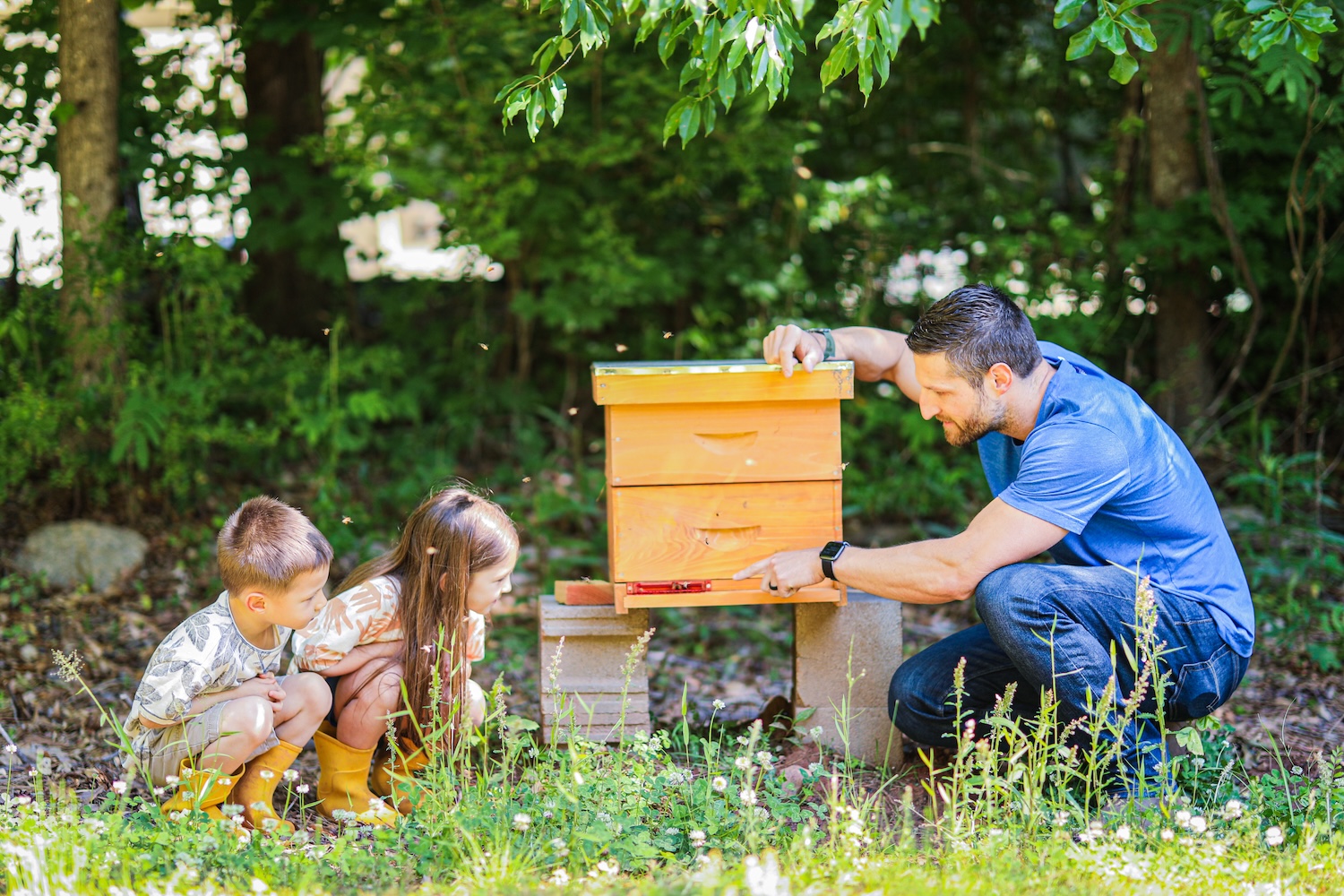 Michael and the kids inspecting a bee hive